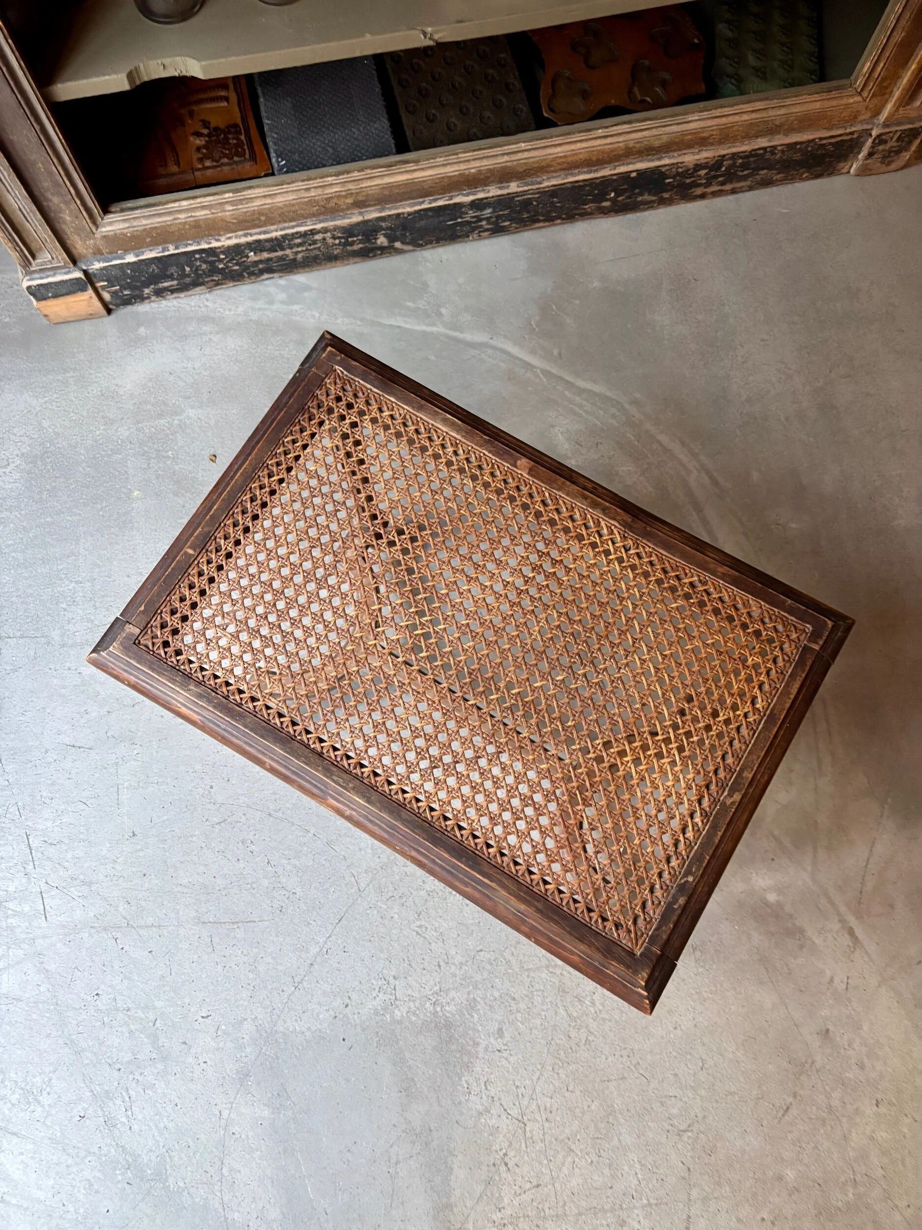 Stool, small wooden piano bench with carved details and caning.