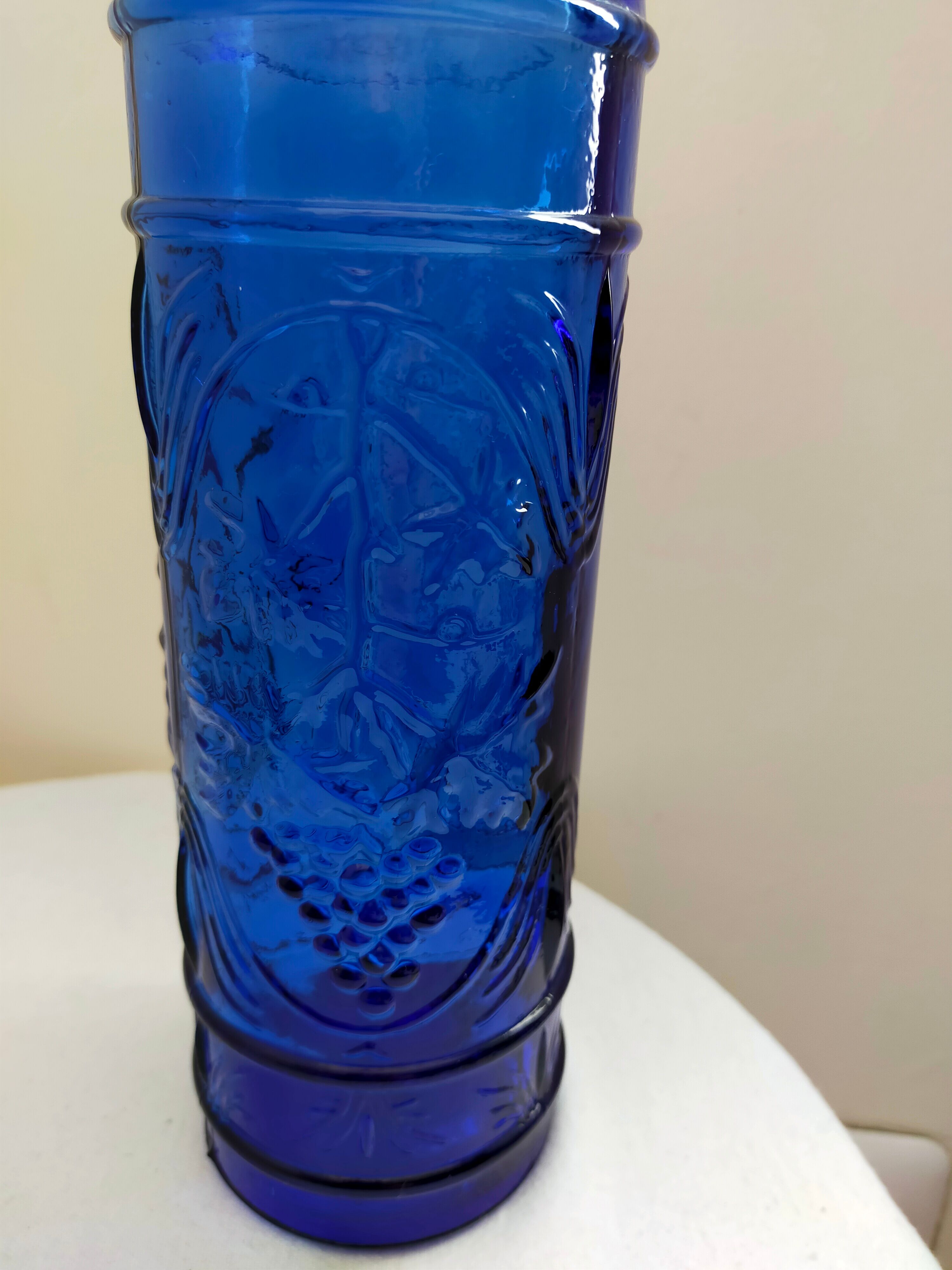 cobalt blue molded glass bottle in relief decoration bunches of grapes