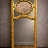 Very large mirror with mouldings, richly carved and gilded, in the Louis XVI style.