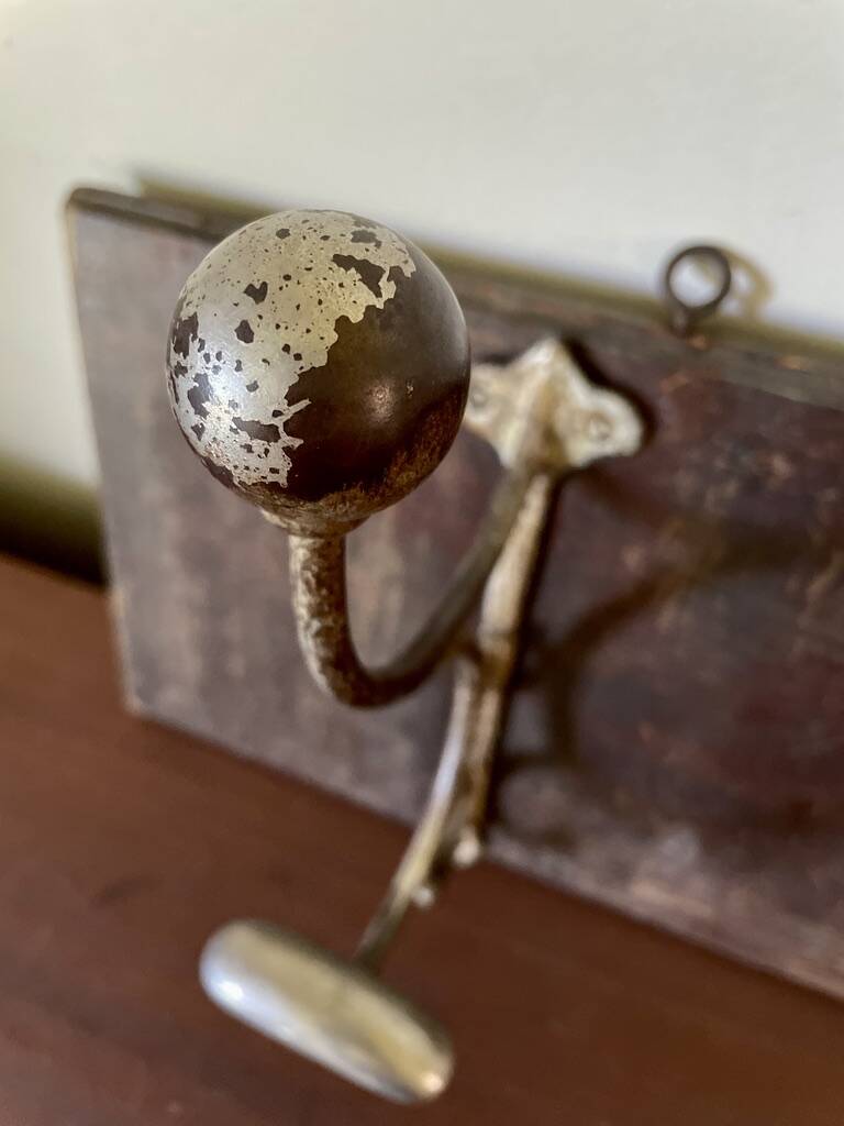 Patinated wood and metal coat rack from the 1950s.
