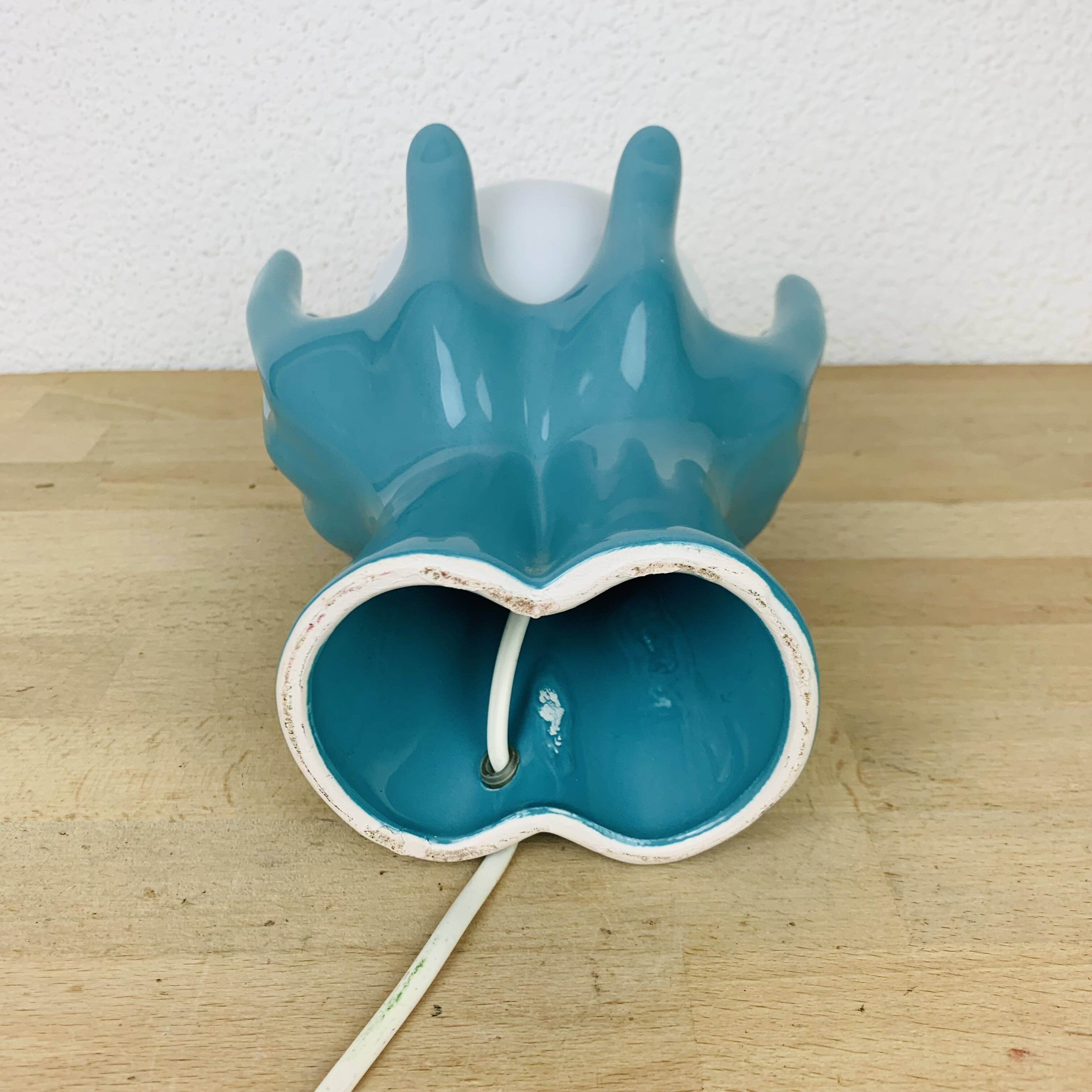 Blue ceramic hands lamp and glass globe