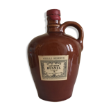 Old bottle of Calvados in sandstone