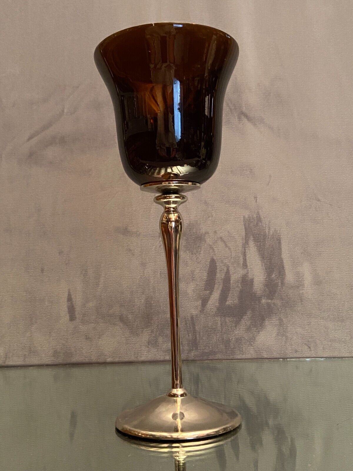 Tinted glass photophore on high metal foot with silver patina