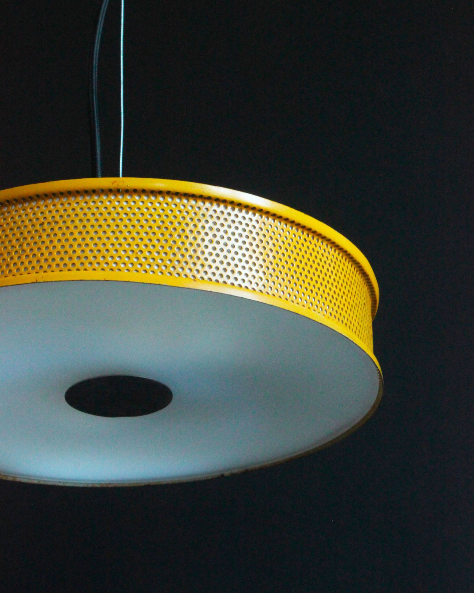 Yellow lacquered perforated metal pendant, in the style of Matégot or Biny.