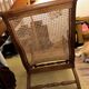 Colonial planter's armchair in solid teak, scroll armrests, caned seat.