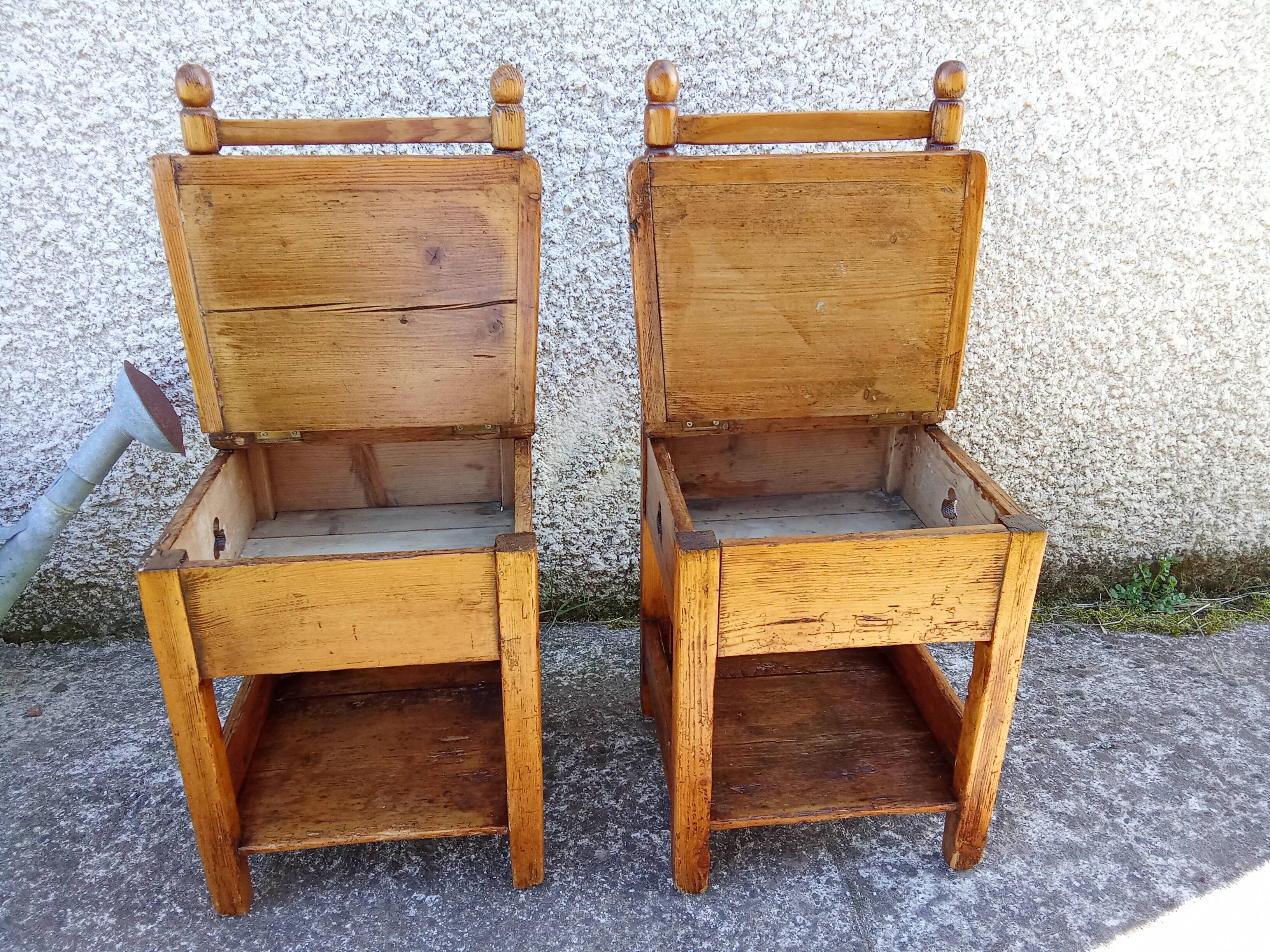 2 old wooden children's chairs with a small chest.