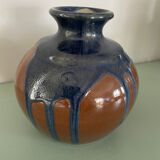 Old blue and brown vase with drips.