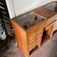 Counter, glass-fronted wooden workbench in dark wood, 8 drawers.