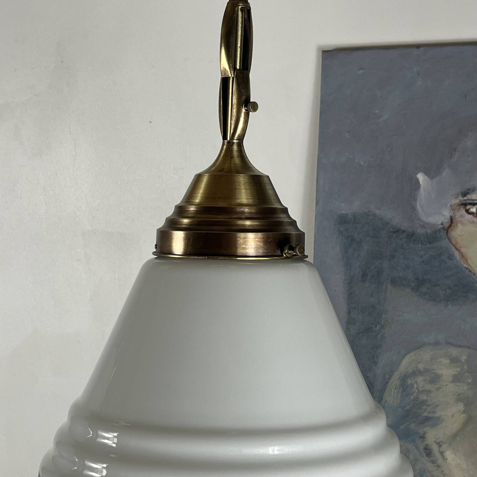 Pair of opaline glass pendant lights in white by Philips and brass from the 1920s.
