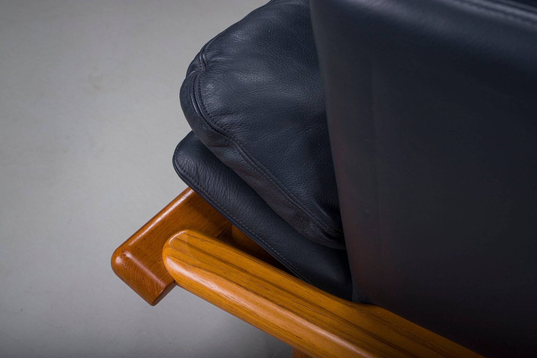 Danish teak and navy blue leather lounge chair from Komfort, 1970s