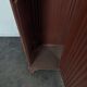 Red painted metal workshop locker with two doors.