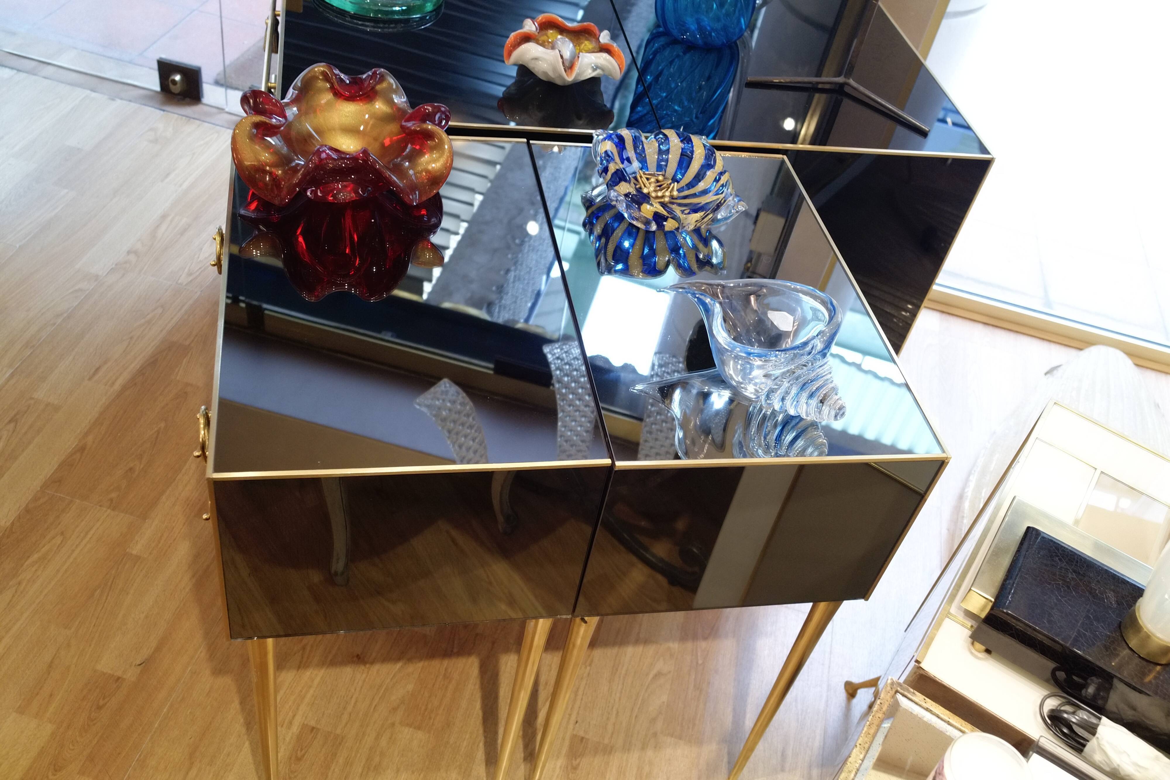 Pair of nightstands in anthracite colored glass and brass