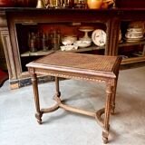 Stool, small wooden piano bench with carved details and caning.