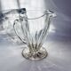 Glass pitcher on base