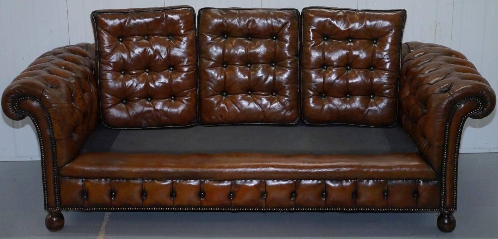Restored vintage leather Chesterfield canapé in Thomas Chippendale style.