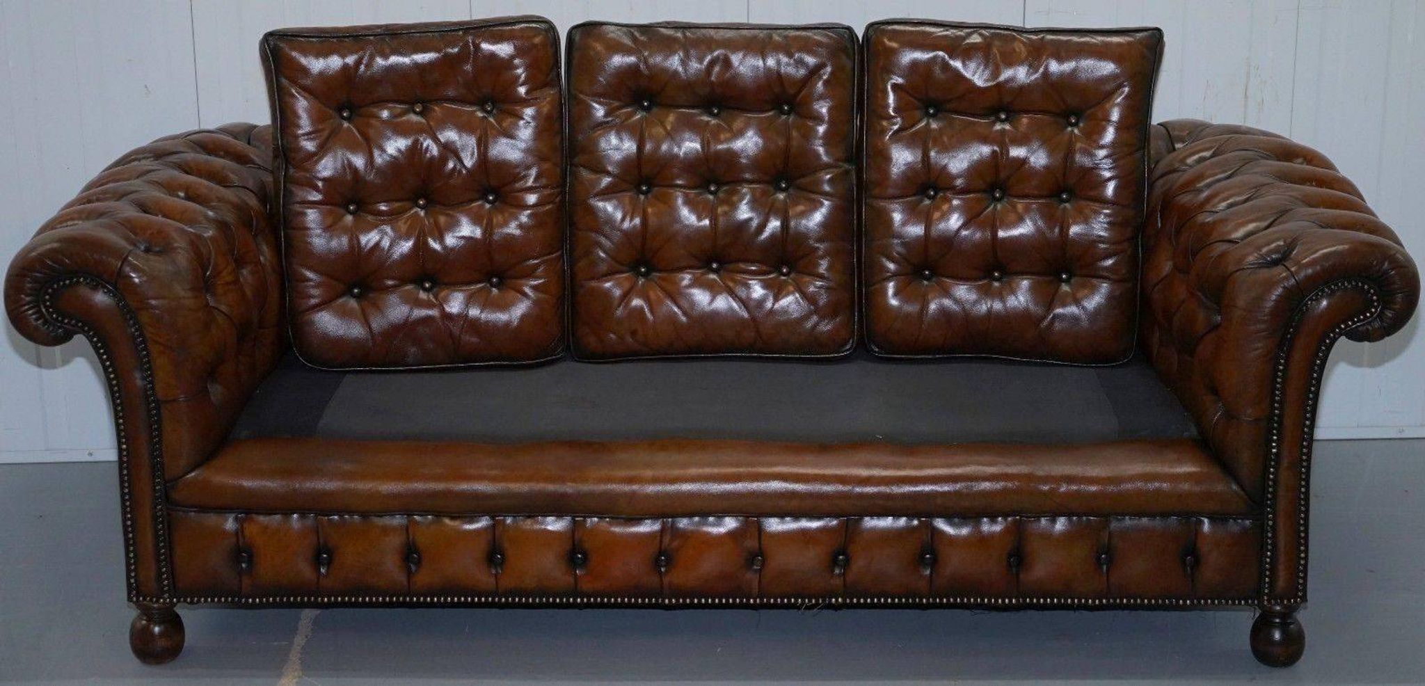 Restored vintage leather Chesterfield canapé in Thomas Chippendale style.