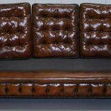 Restored vintage leather Chesterfield canapé in Thomas Chippendale style.