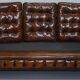 Restored vintage leather Chesterfield canapé in Thomas Chippendale style.