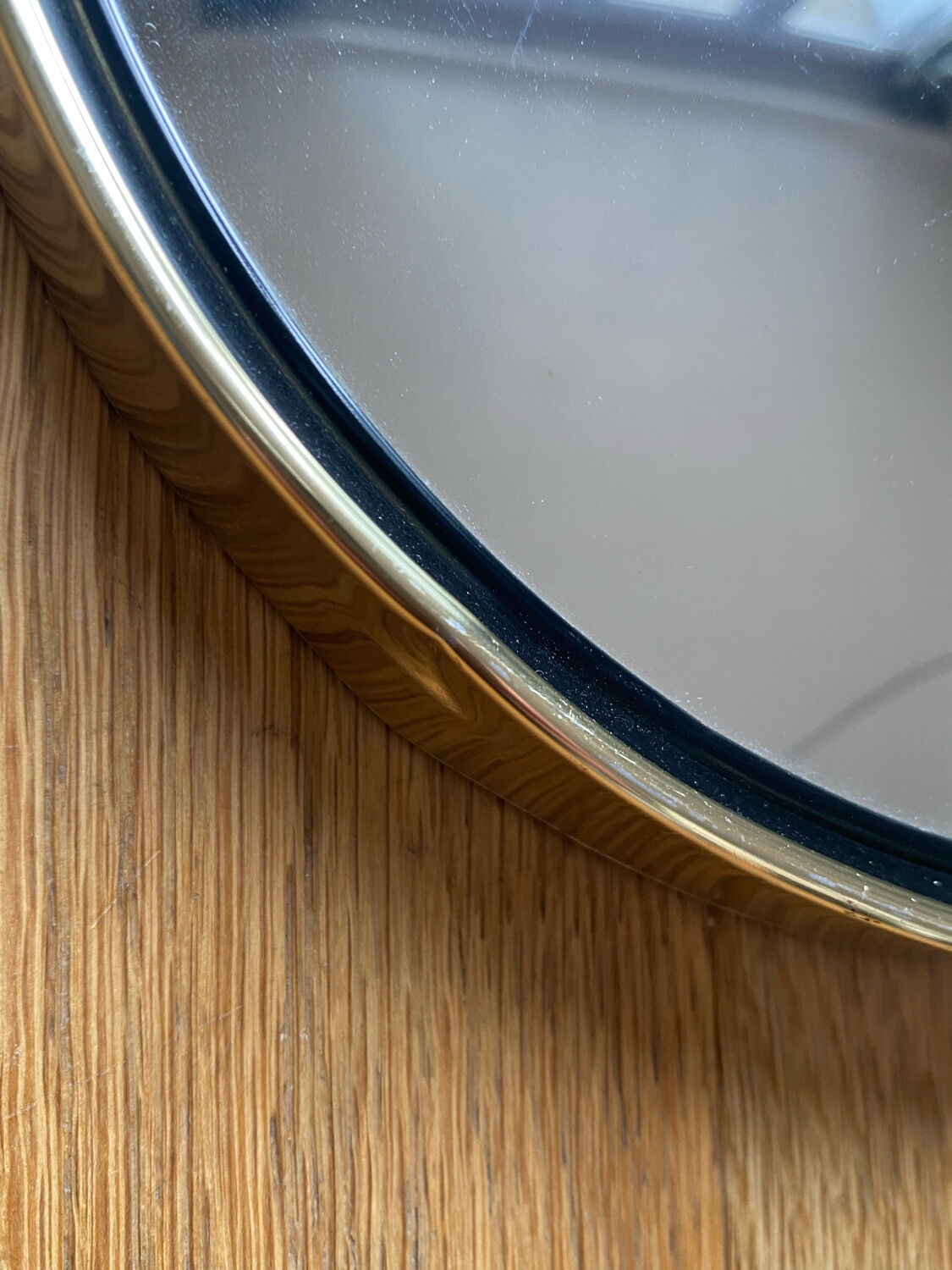 Vintage witch's eye curved mirror hangs velvet ribbon