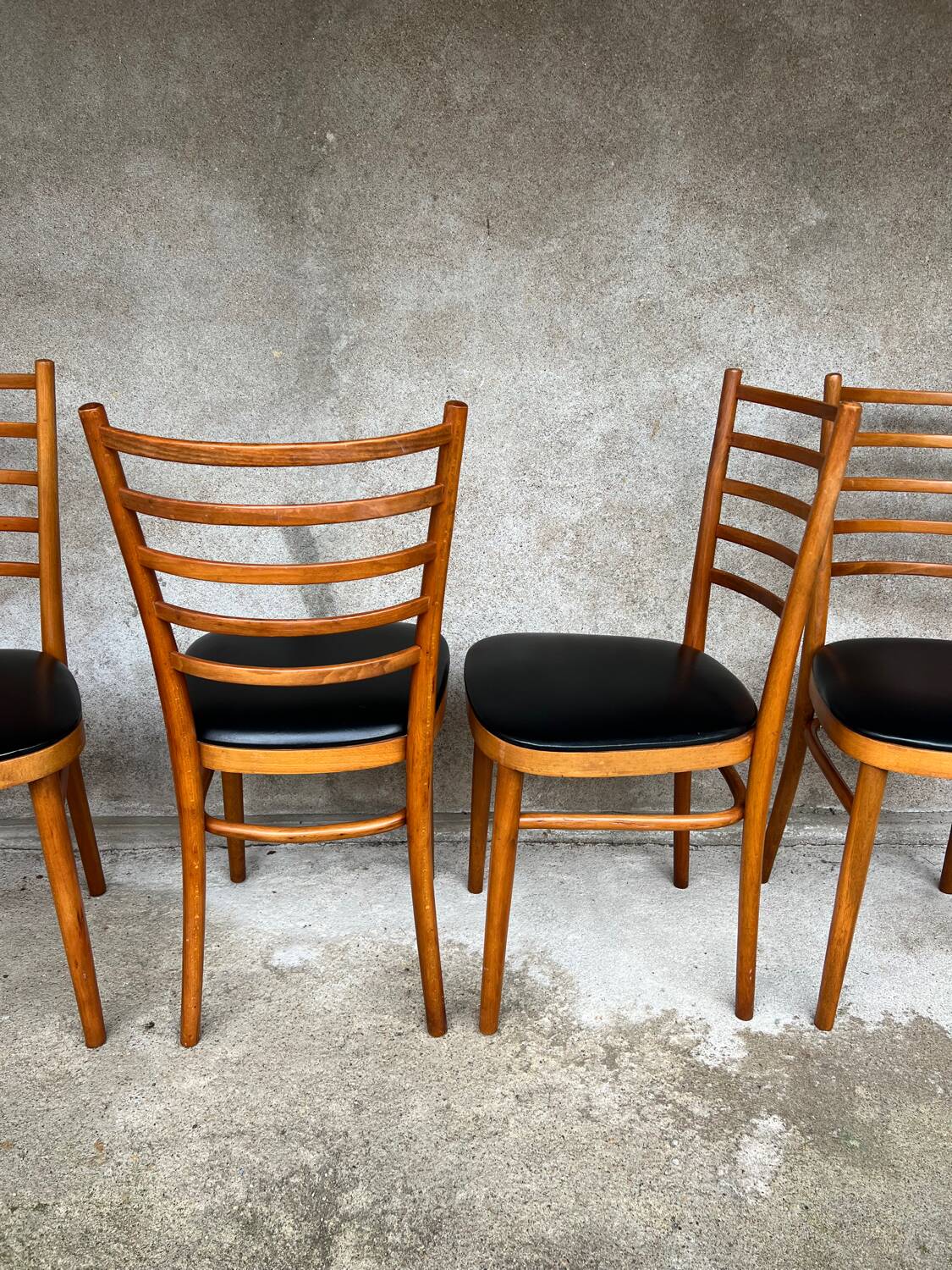 Set of 4 vintage wooden chairs with faux leather.
