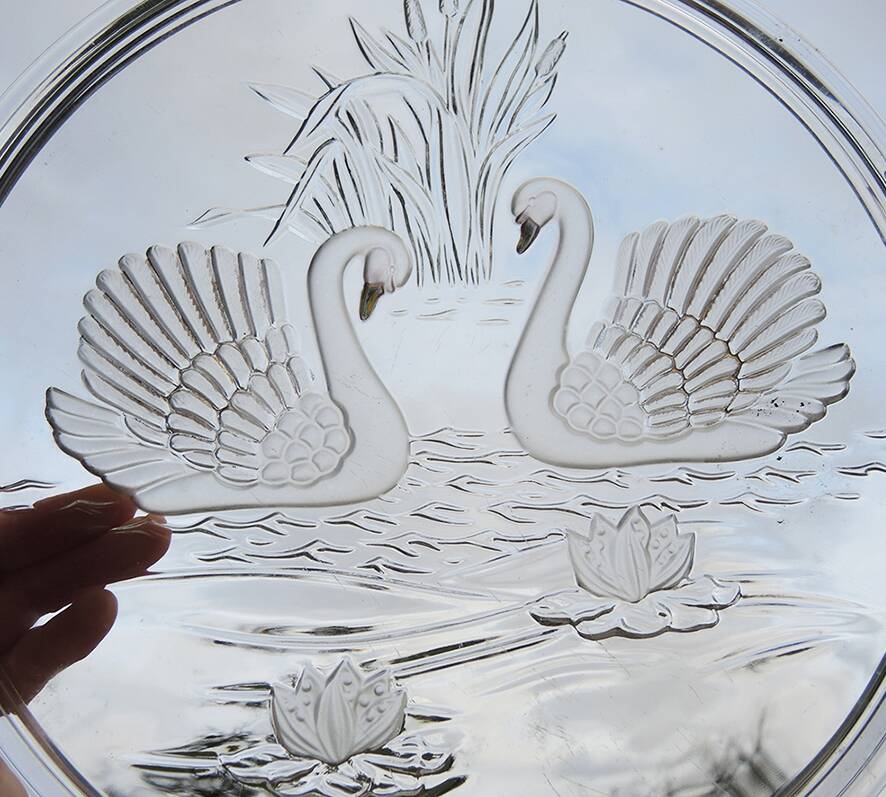 Vintage glass cake stand with swan decoration.