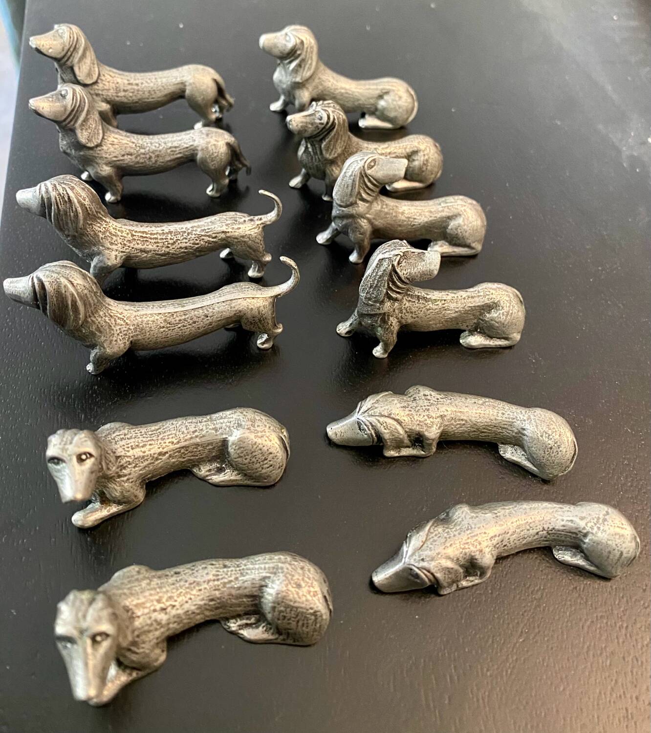 12 old dog-shaped Etains du Manoir knife holders