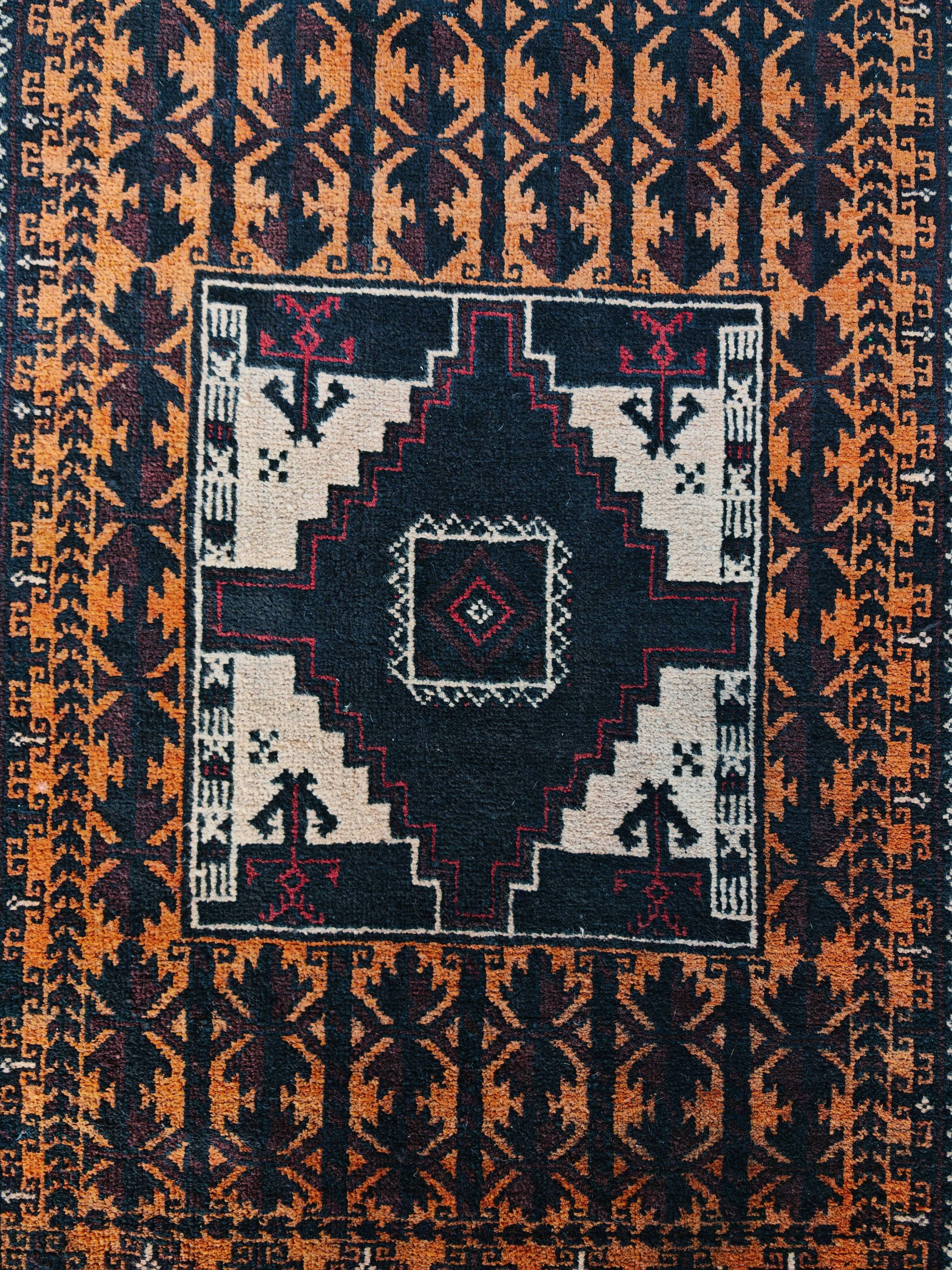 Vintage Persian Baluch rug, hand-knotted wool, 1970.