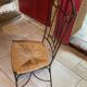 Table and four wrought iron and wood chairs.