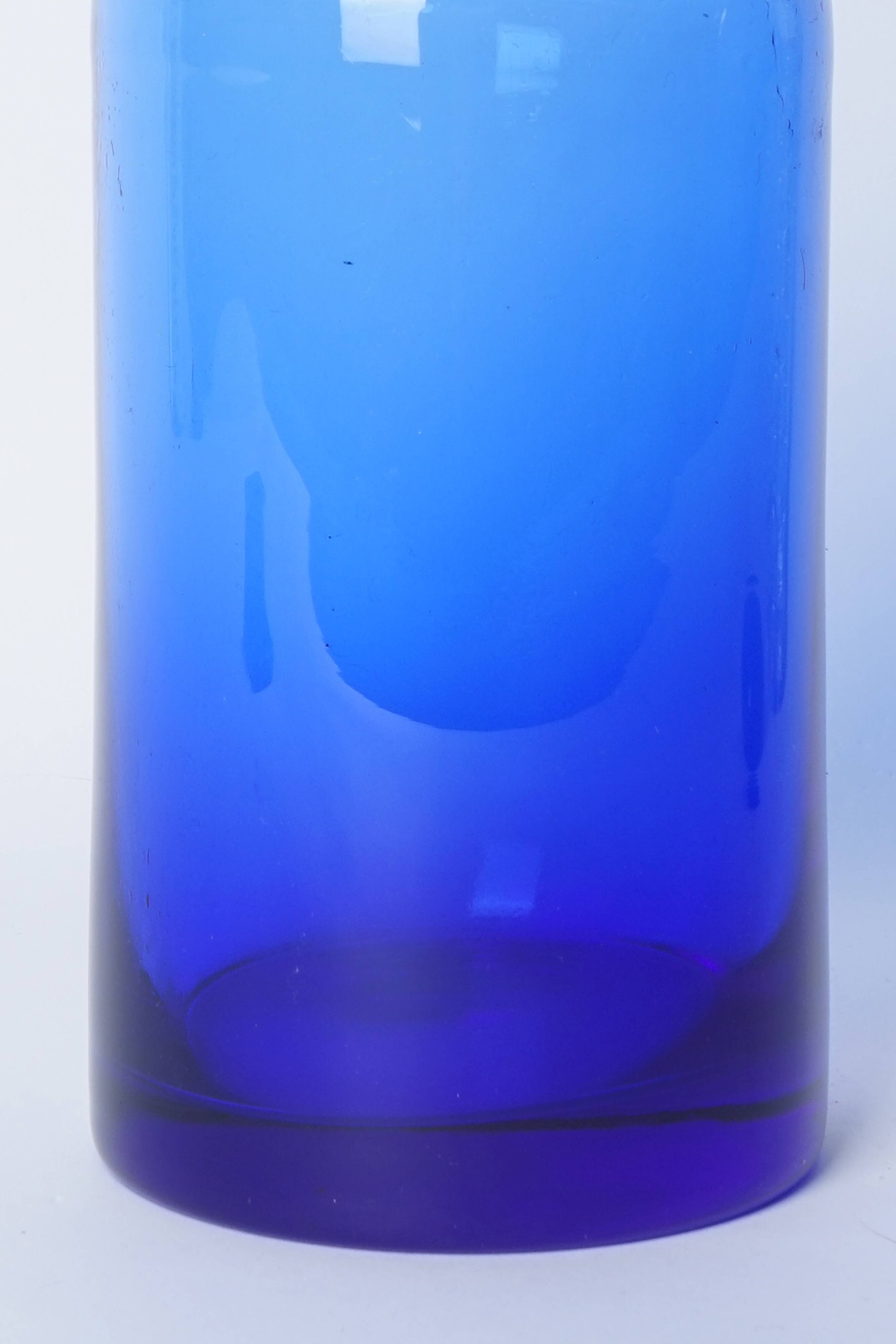 Lighter blue glass vase at the top