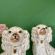 Pair of Staffordshire-type dogs in white and gold ceramic