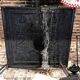 huge old fireplace plate has decoration of angels, crown and fleurs-de-lis