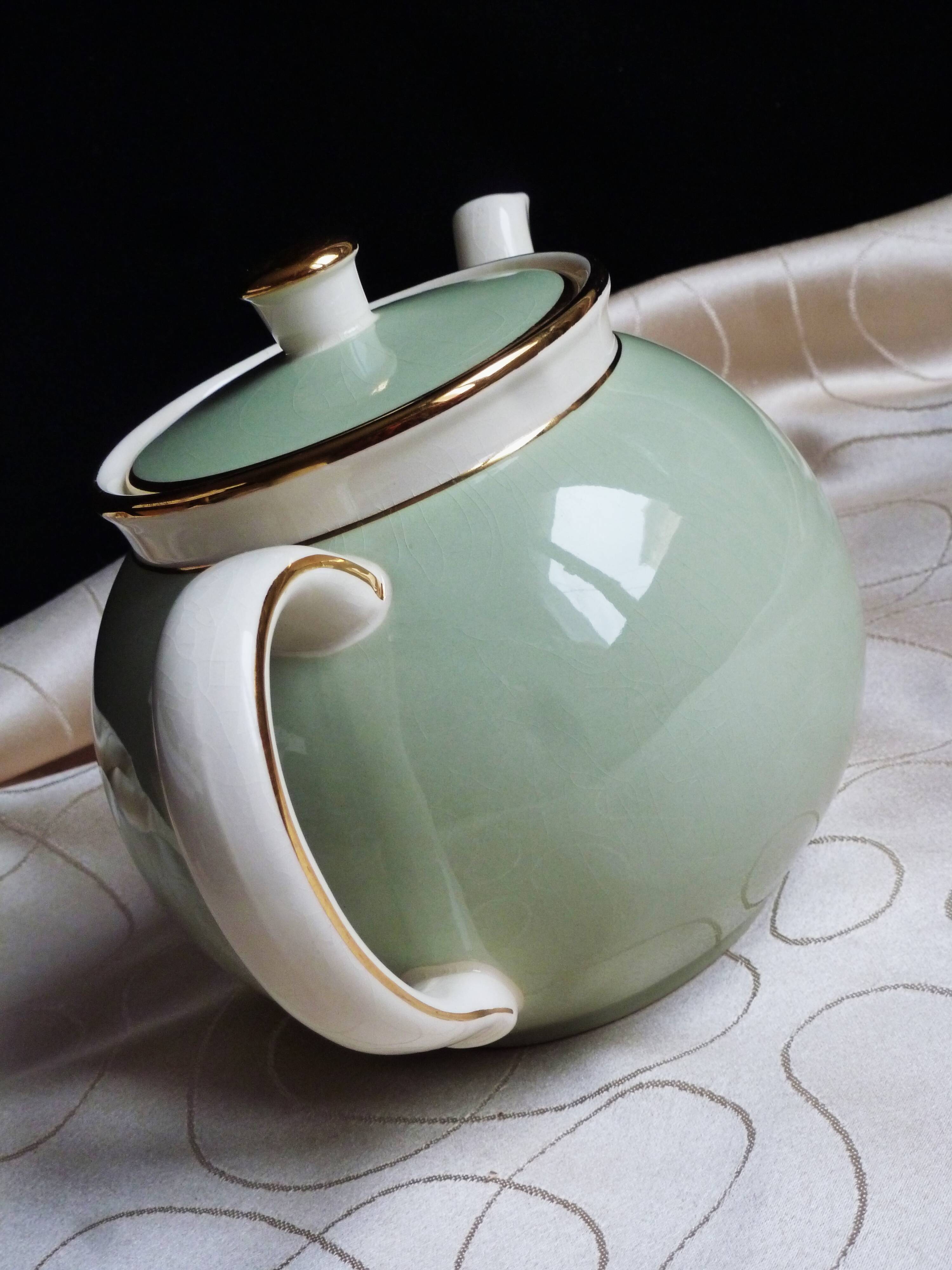 Antique Villeroy and Boch ceramic teapot in gold and celadon green.
