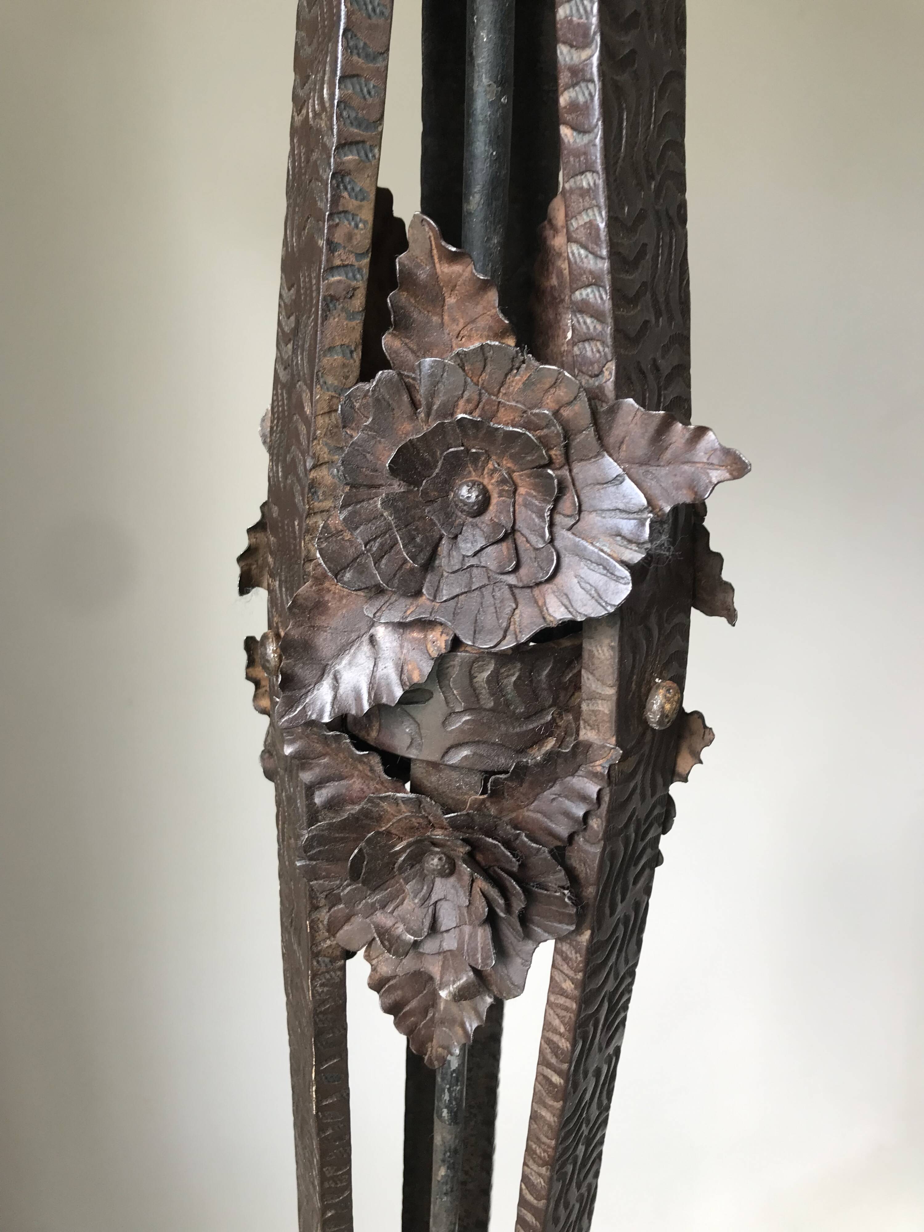 Art deco wrought iron floor lamp decorated with flowers, circa 1930.