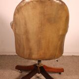 Office chair known as a presidential chair in mahogany and cognac leather.