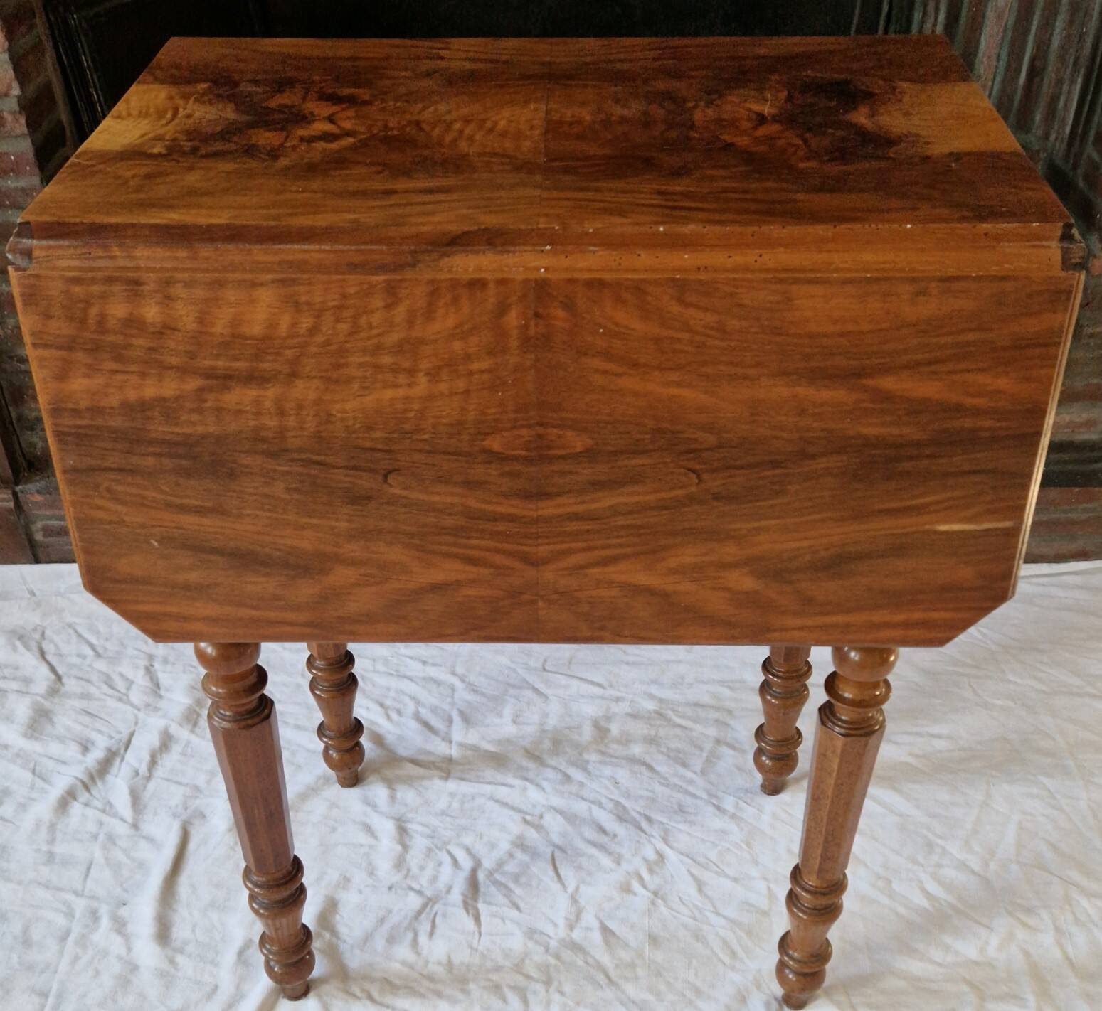 Nineteenth-century walnut work table with flaps, large storage + secret drawer.