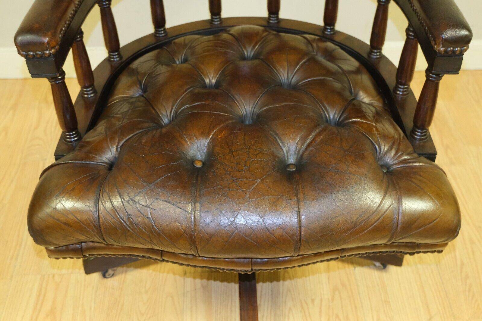 Restored Chesterfield captain's armchair in leather with an oak frame.