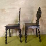 Duo of carved wooden chairs