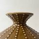 Pyriform vase in glazed ochre ceramic and beads.