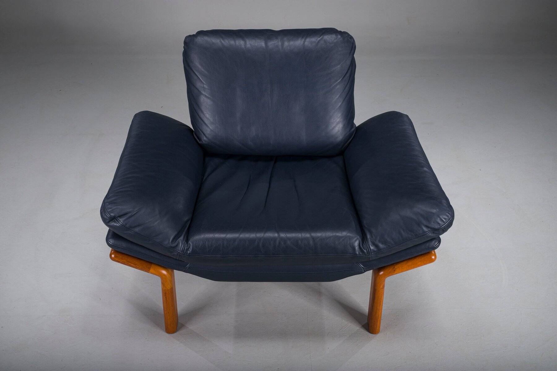 Danish teak and navy blue leather lounge chair from Komfort, 1970s