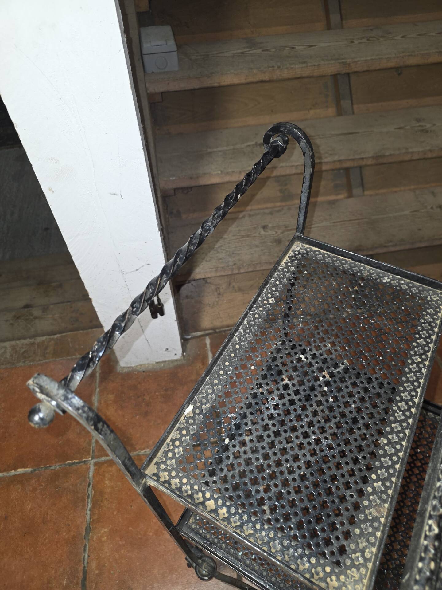 Perforated wrought iron rolling dessert trolley