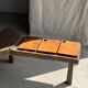 Small rectangular teak monoxyle cutting board with a circular handle.