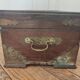 Old Indian wooden wedding chest decorated with chiseled brass plaque. India late 19th/early 20th
