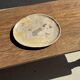 Petrified wood catchall or dish in beige with several grey spots in the centre.