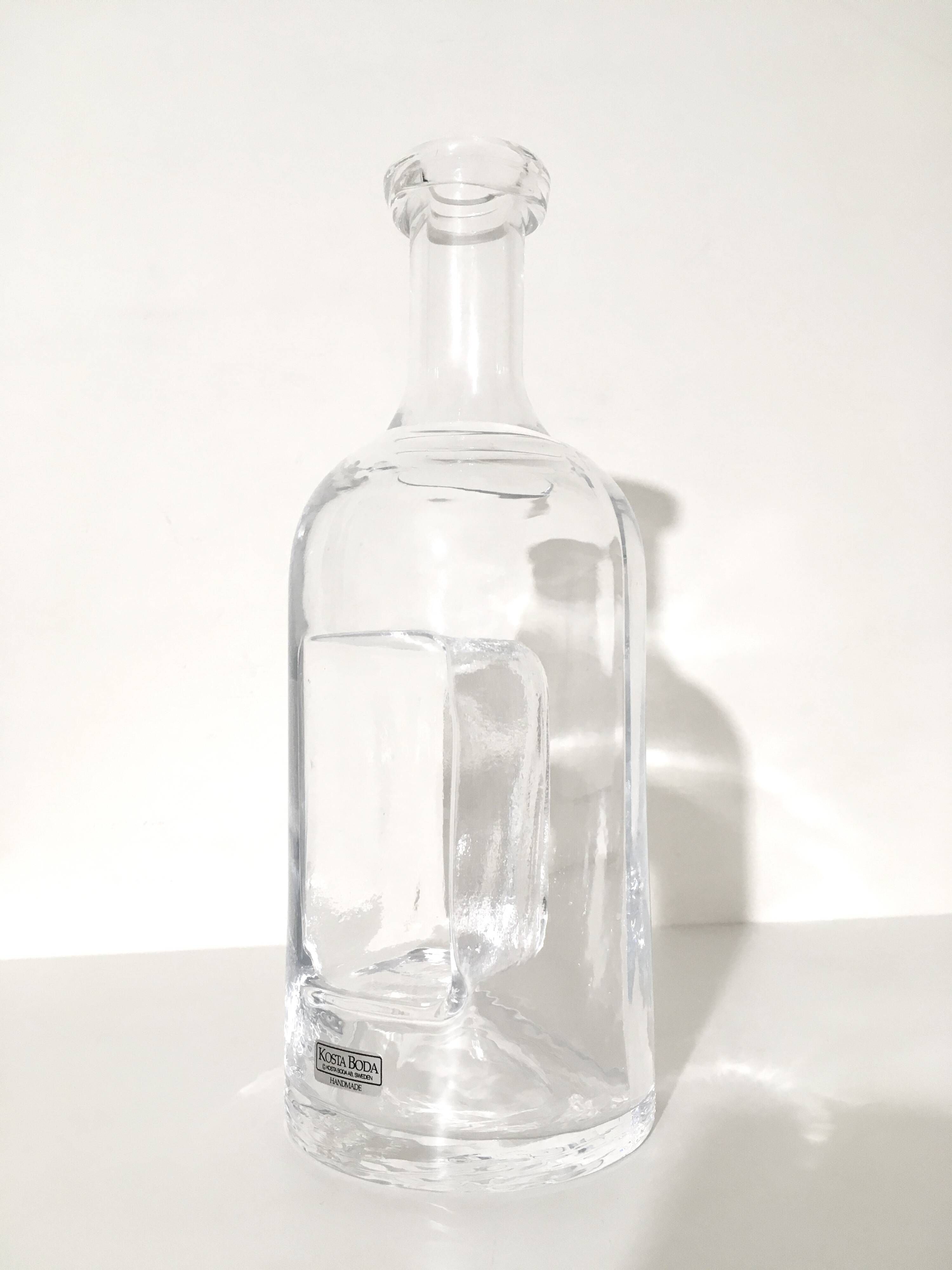 Kosta Boda carafe in blown glass 26 cm with sculptural imprint • Sweden
