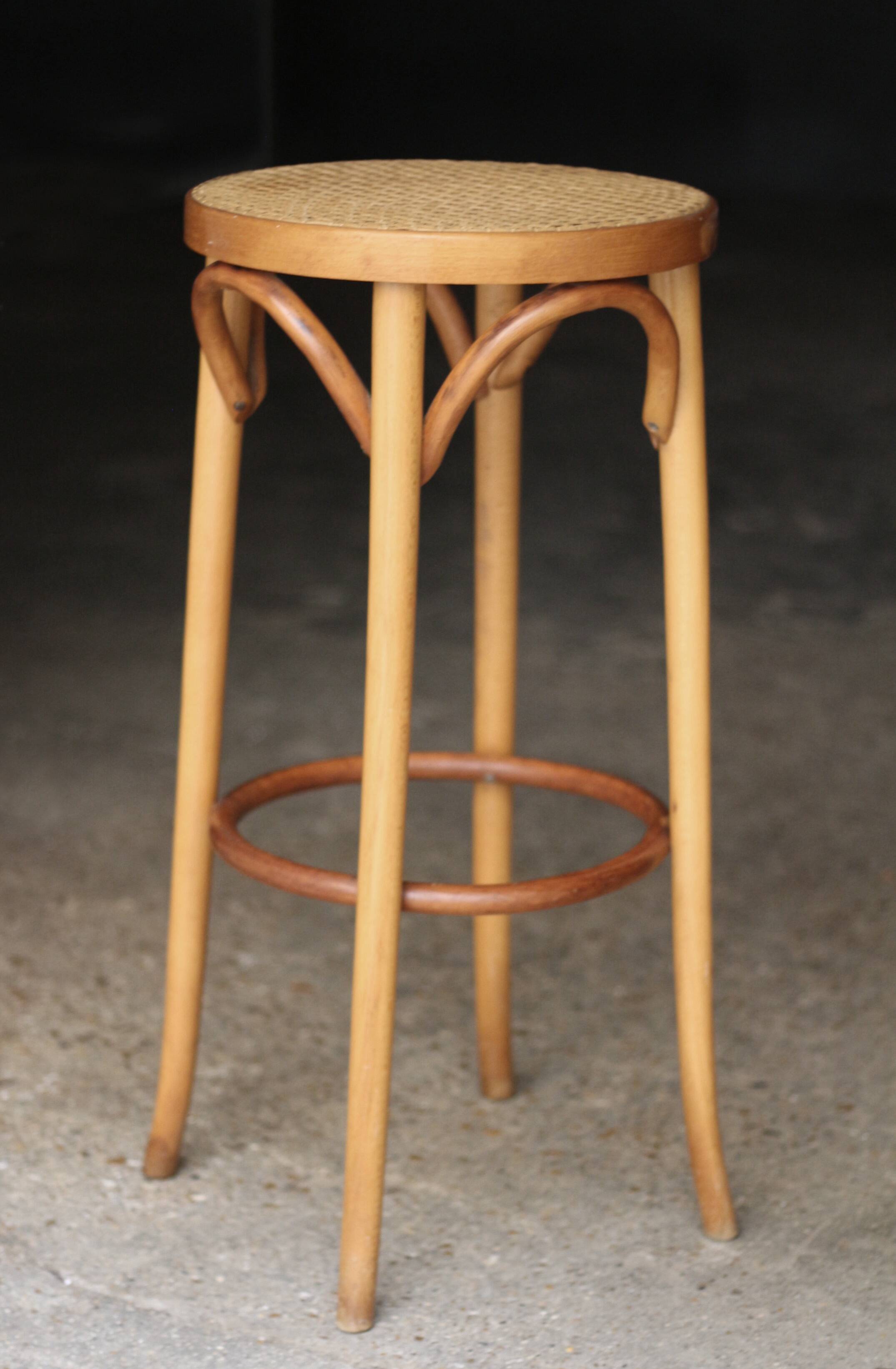Beautiful caned stool in curved blond wood. 1940s/1950s