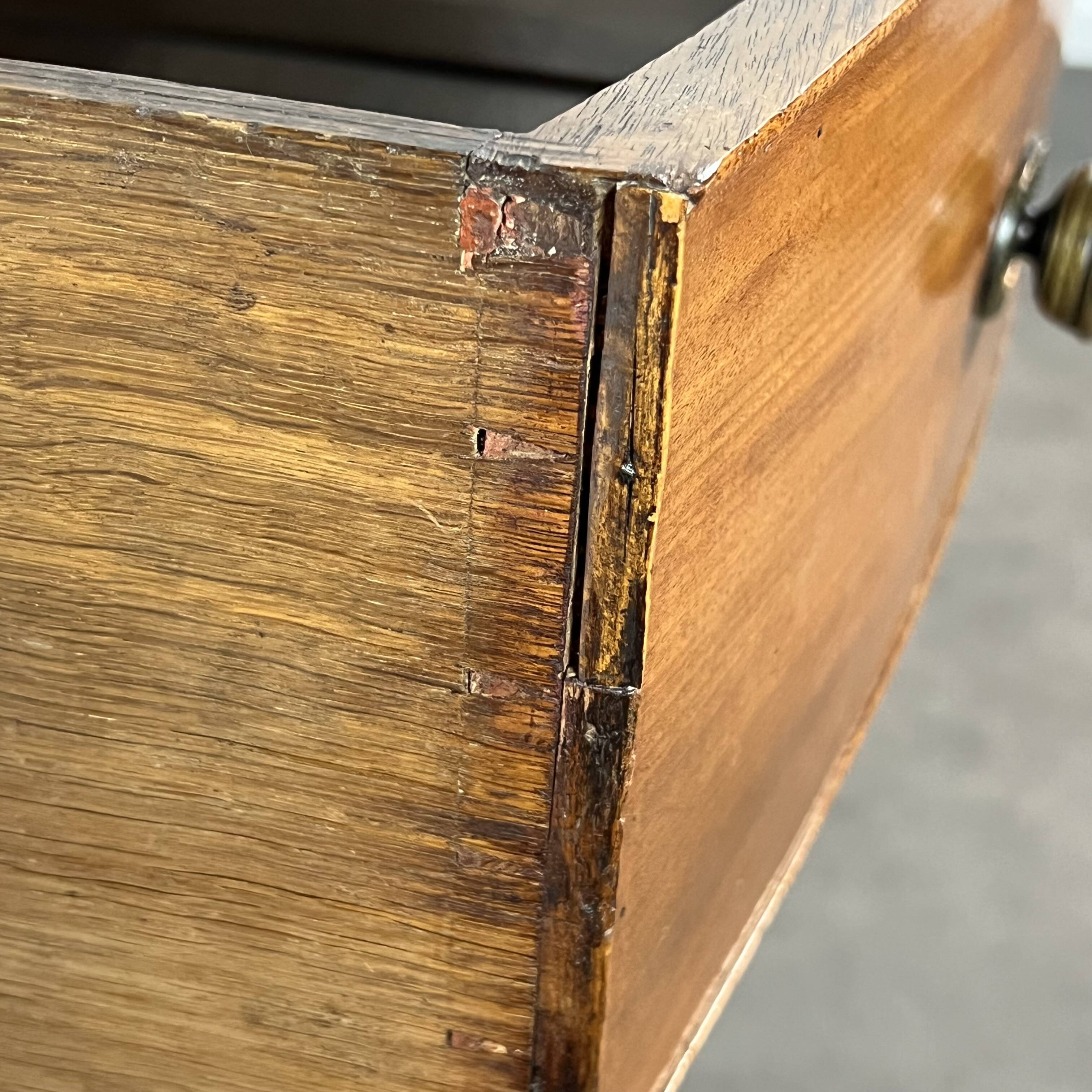 English commode from the George III Regency period, bombe shape in mahogany veneer.