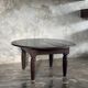 Antique round coffee table in Indonesian teak with turned legs.