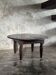 Antique round coffee table in Indonesian teak with turned legs.