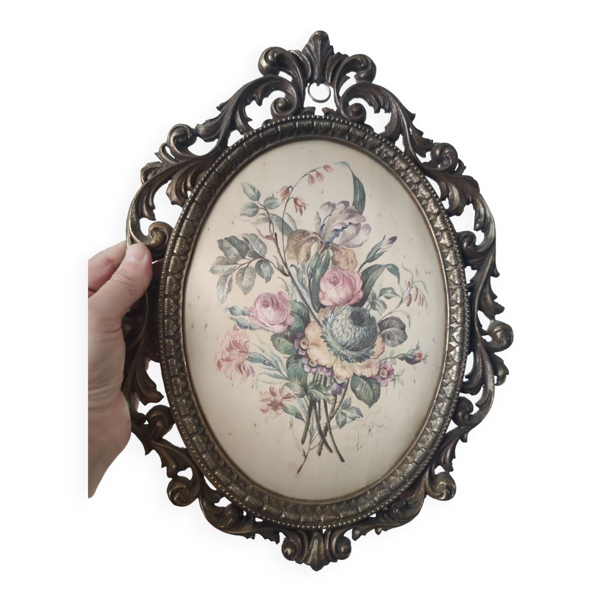 Golden brass frame with bouquet of flowers on silky fabric