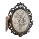 Golden brass frame with bouquet of flowers on silky fabric
